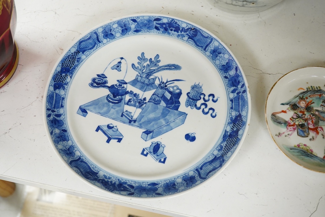 A 19th Century Chinese blue and white ‘precious objects’ plate, a jar and famille rose saucer, largest 23cm in diameter